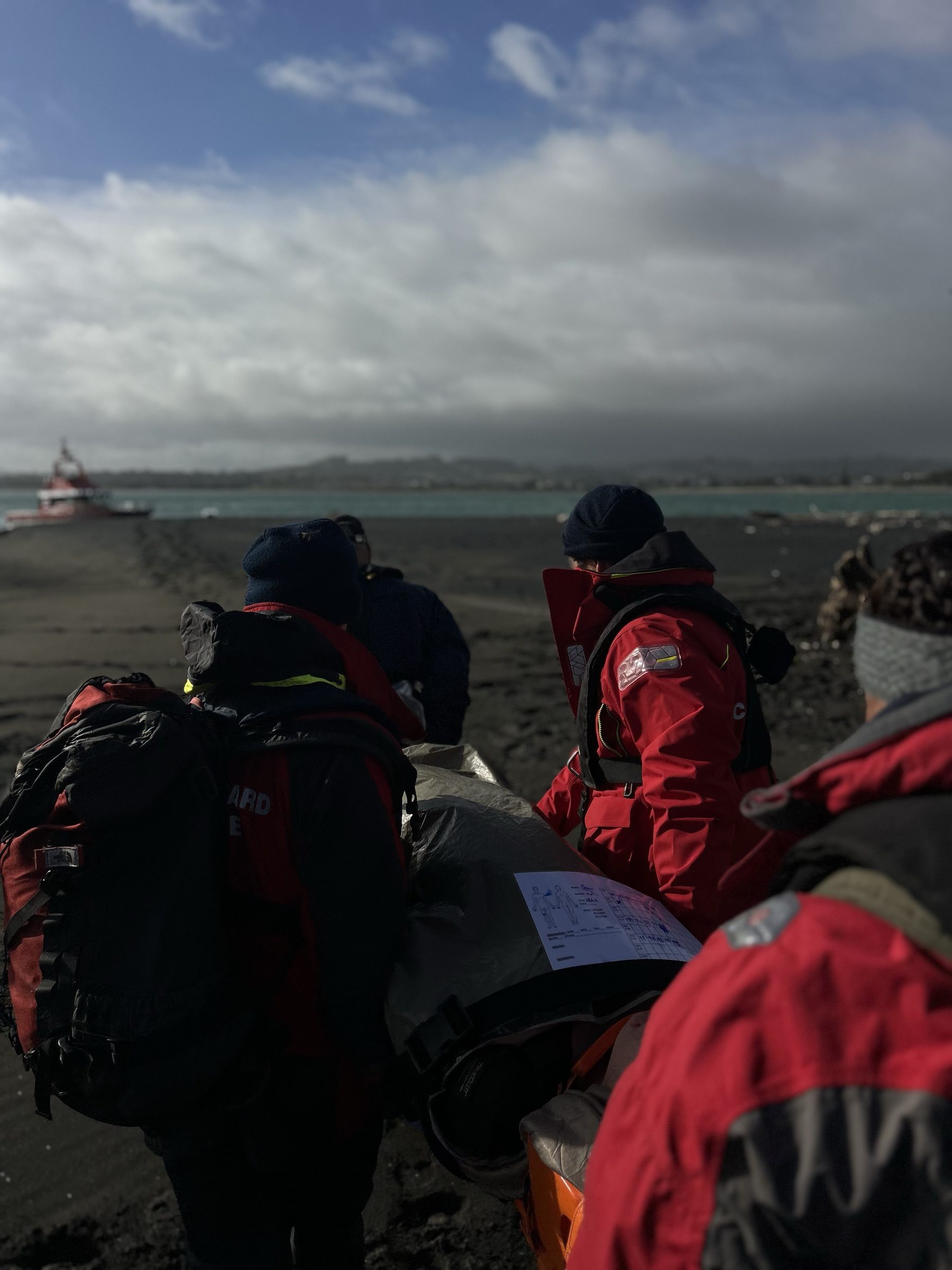 A medic and team carrying a casualty on a stretcher during a live exercise